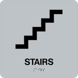 Square Shape Stairs Braille Sign. Silver background with black stairs graphic, text and braille. With adhesive back for easy install.